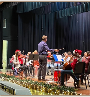 conductor leading band at Christmas concert